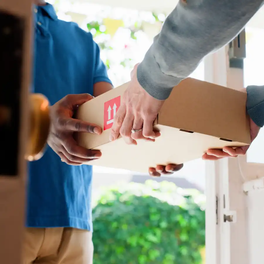 A customer receives her online order at home.